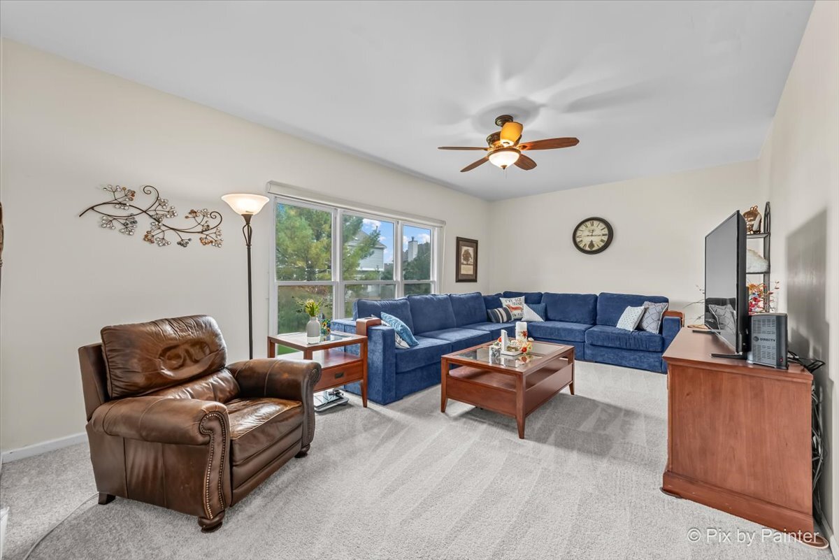 1820 Crofton Drive Algonquin, IL 60102 - Photo 17 of 60 a living room with furniture ceiling fan and a window