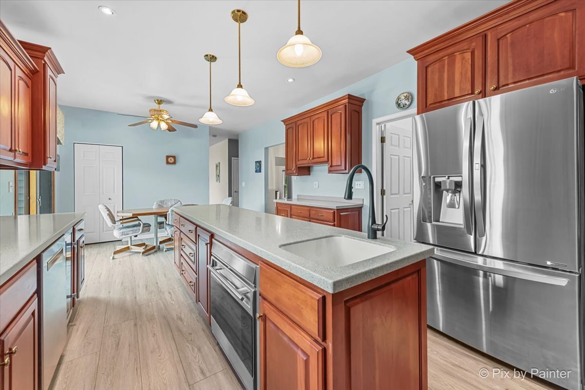 1820 Crofton Drive Algonquin, IL 60102 - Photo 22 of 60 a kitchen with stainless steel appliances granite countertop a refrigerator a sink dishwasher a stove and a refrigerator with wooden floor