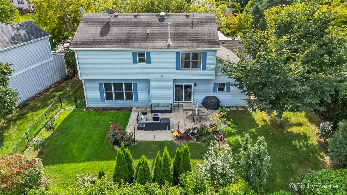 1820 Crofton Drive Algonquin, IL 60102 - Photo 3 of 60 a view of a house with a yard patio and a fire pit