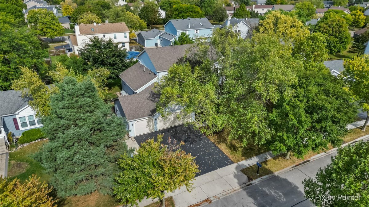 1820 Crofton Drive Algonquin, IL 60102 - Photo 52 of 60 an aerial view of a house with a yard and trees all around