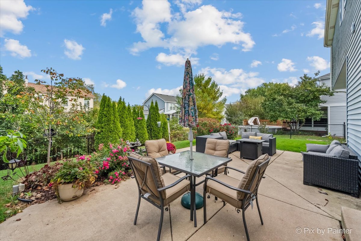 1820 Crofton Drive Algonquin, IL 60102 - Photo 8 of 60 a view of a patio with couches and table and chairs and potted plants