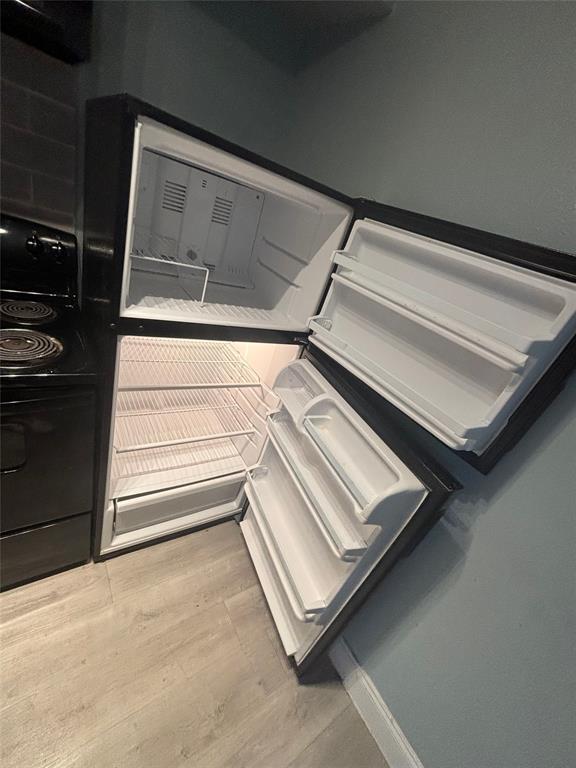 301 Rolston Road, Unit 305101 Irving, TX 75060 - Photo 3 of 7 Black top-freezer refrigerator with clear interior shelving
