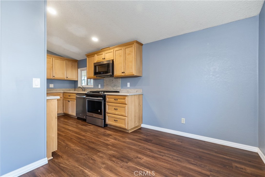 1220 Bennett Way, Unit 1 Templeton, CA 93465 - Photo 12 of 37 a kitchen with granite countertop a stove top oven and cabinets