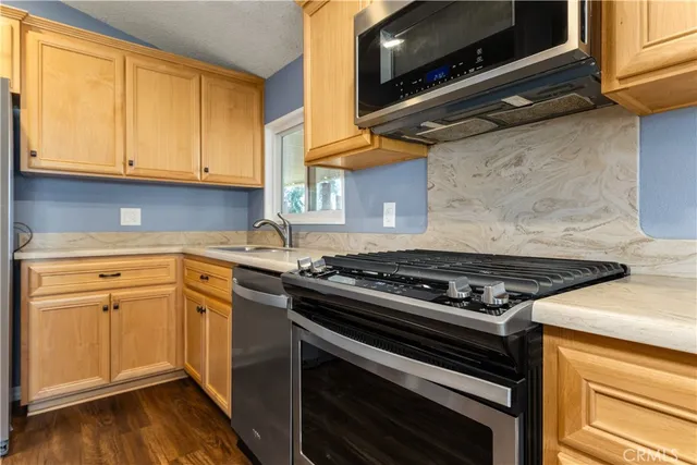a kitchen with granite countertop a stove and a sink