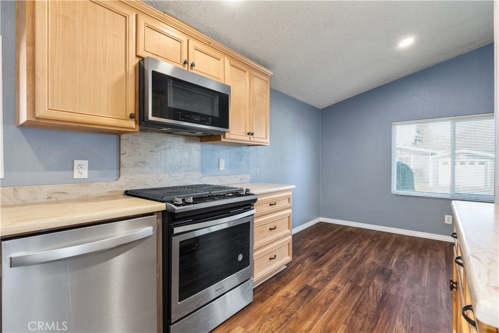 1220 Bennett Way, Unit 1 Templeton, CA 93465 - Photo 15 of 37 a kitchen with stainless steel appliances a stove microwave and sink