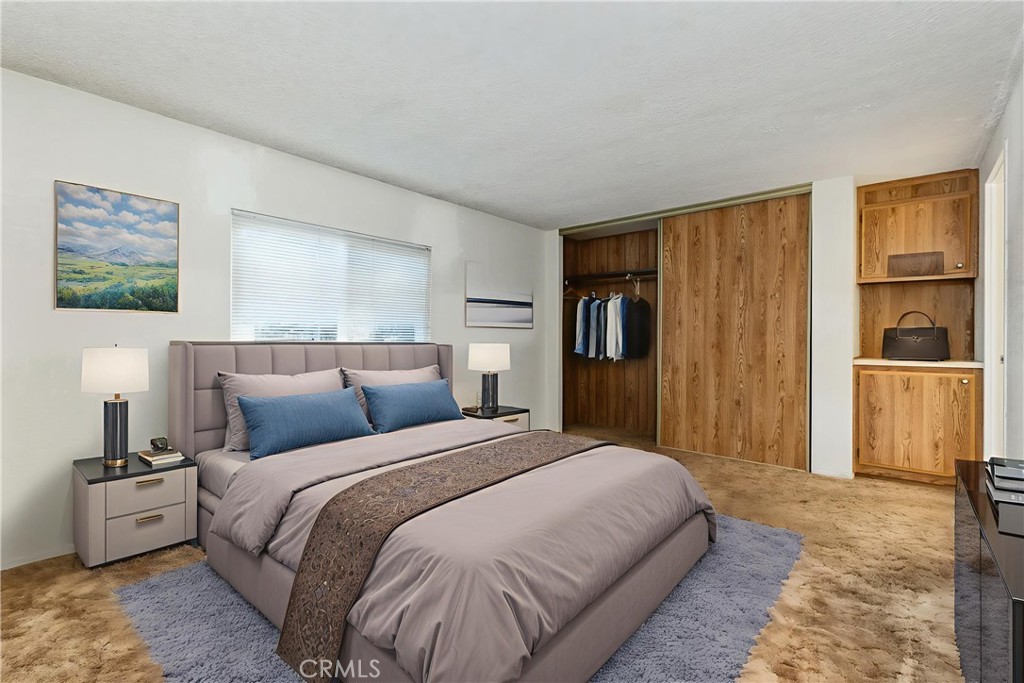 1220 Bennett Way, Unit 1 Templeton, CA 93465 - Photo 24 of 37 a spacious bedroom with a bed and a couch