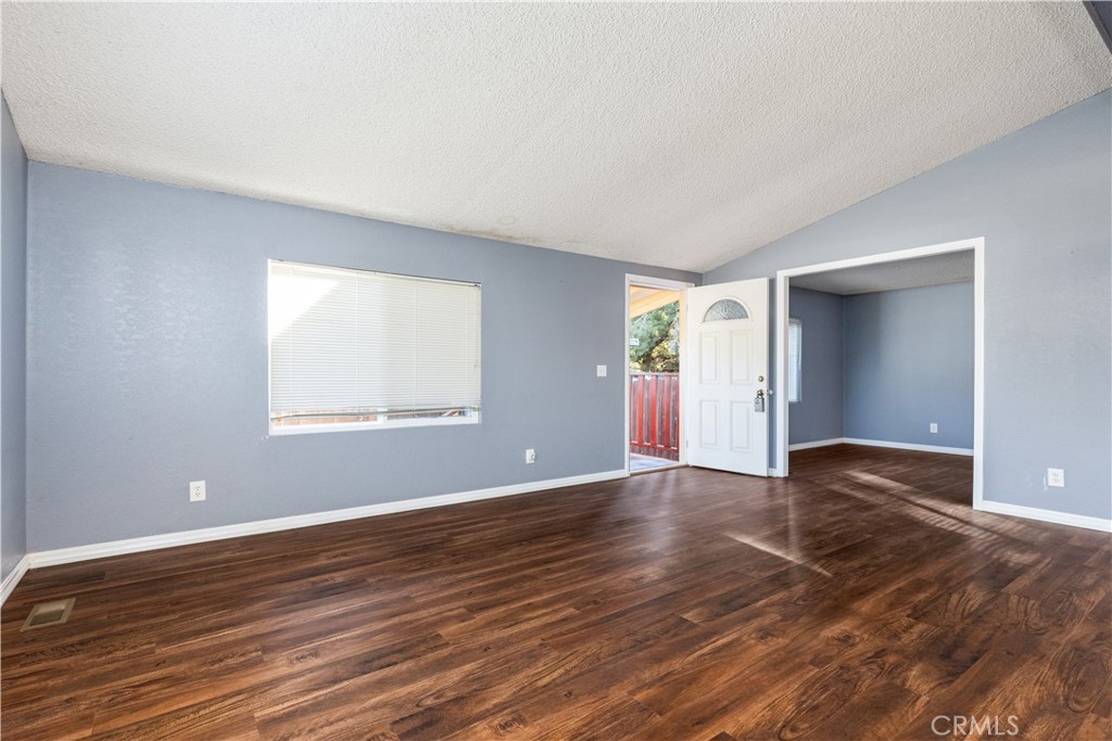 1220 Bennett Way, Unit 1 Templeton, CA 93465 - Photo 7 of 37 an empty room with wooden floor and windows