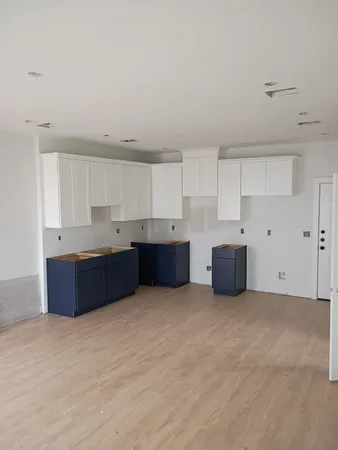 a kitchen with a cabinets and white stainless steel appliances