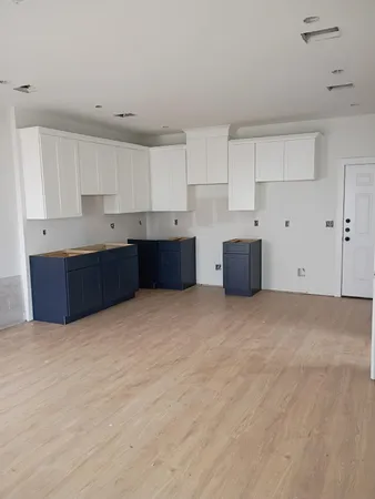 a large kitchen with cabinets and white stainless steel appliances