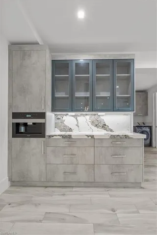 a view of kitchen with granite countertop cabinets and oven