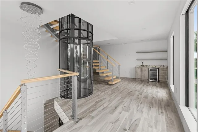 a view of a livingroom with wooden floor staircase