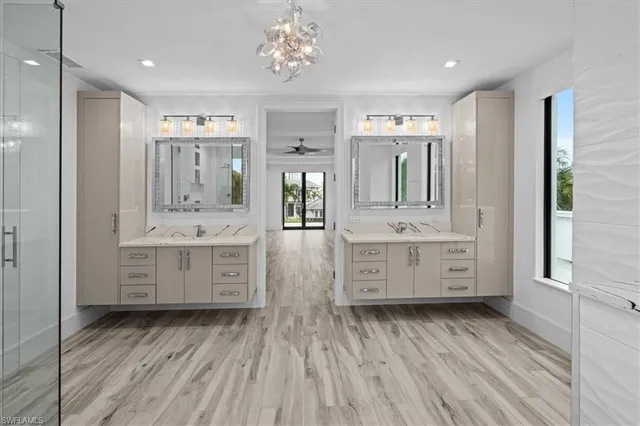 a bathroom with a double vanity sink a mirror and a bathtub