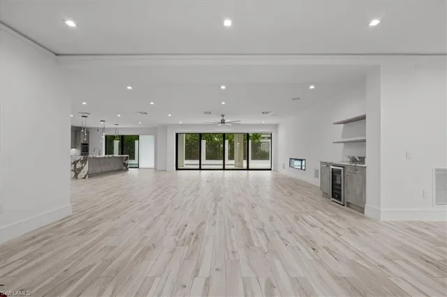 an empty room with wooden floor and fireplace
