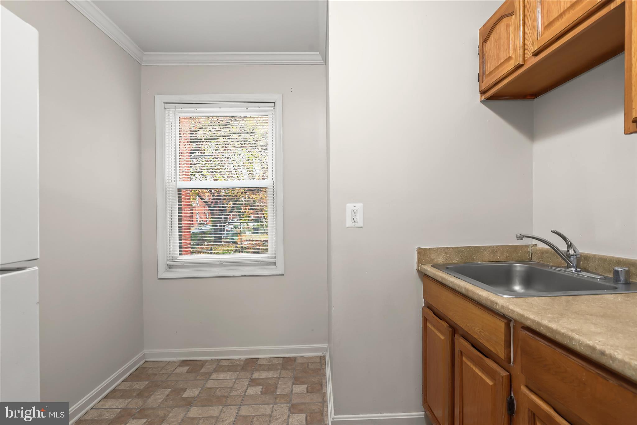 3511 6th Street Baltimore, MD 21225 - Photo 11 of 31 a kitchen with a sink and cabinets