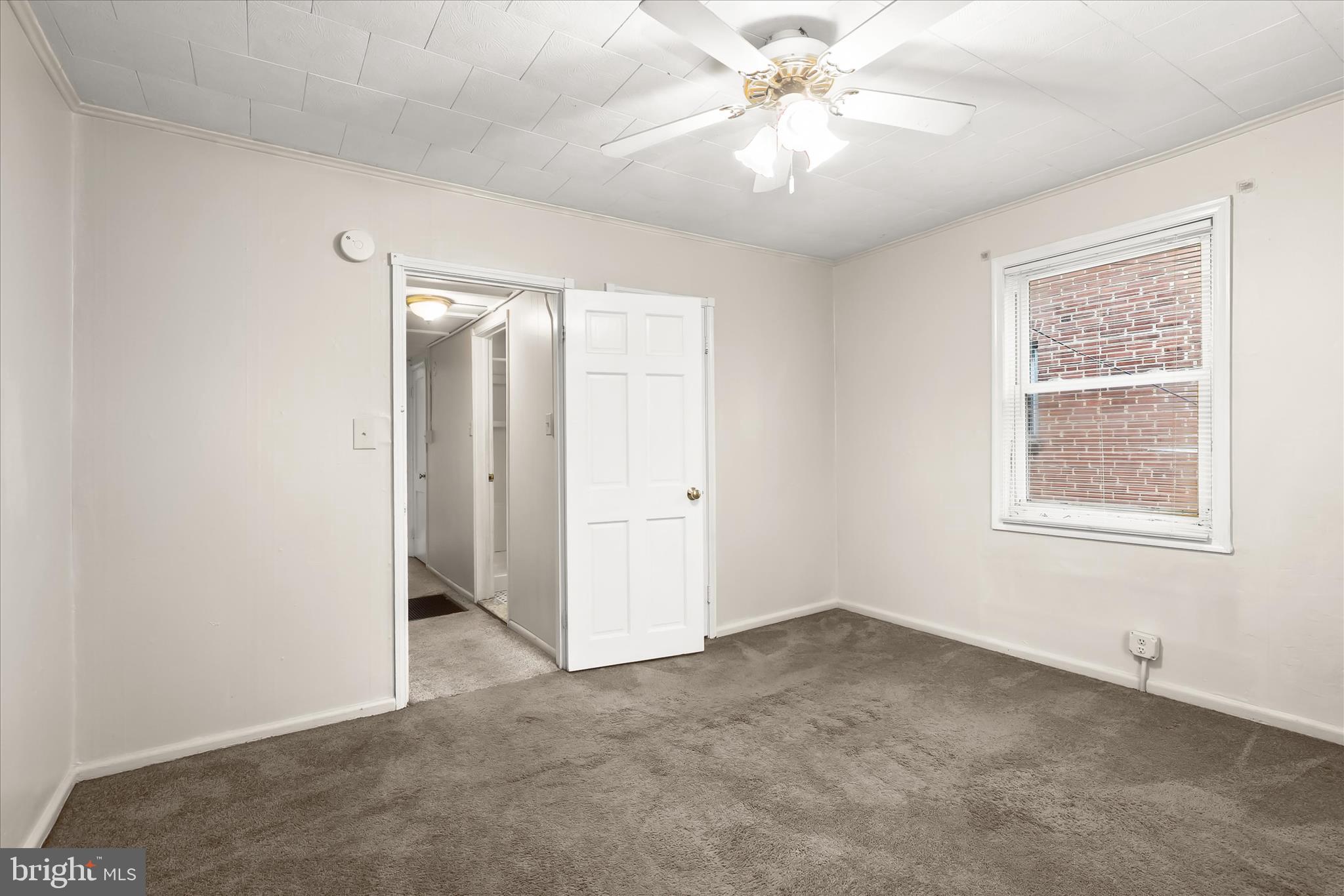 3511 6th Street Baltimore, MD 21225 - Photo 13 of 31 an empty room with chandelier fan and windows