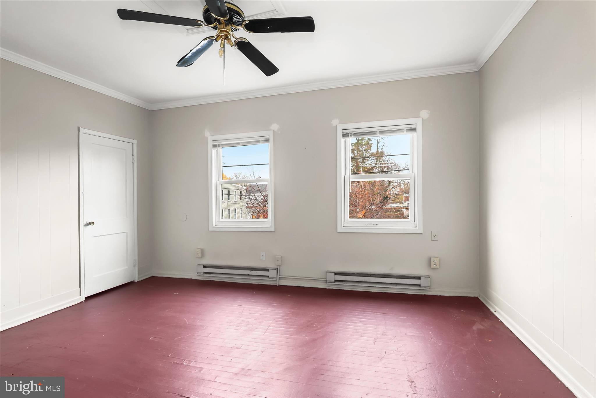 3511 6th Street Baltimore, MD 21225 - Photo 17 of 31 an empty room with chandelier fan and windows