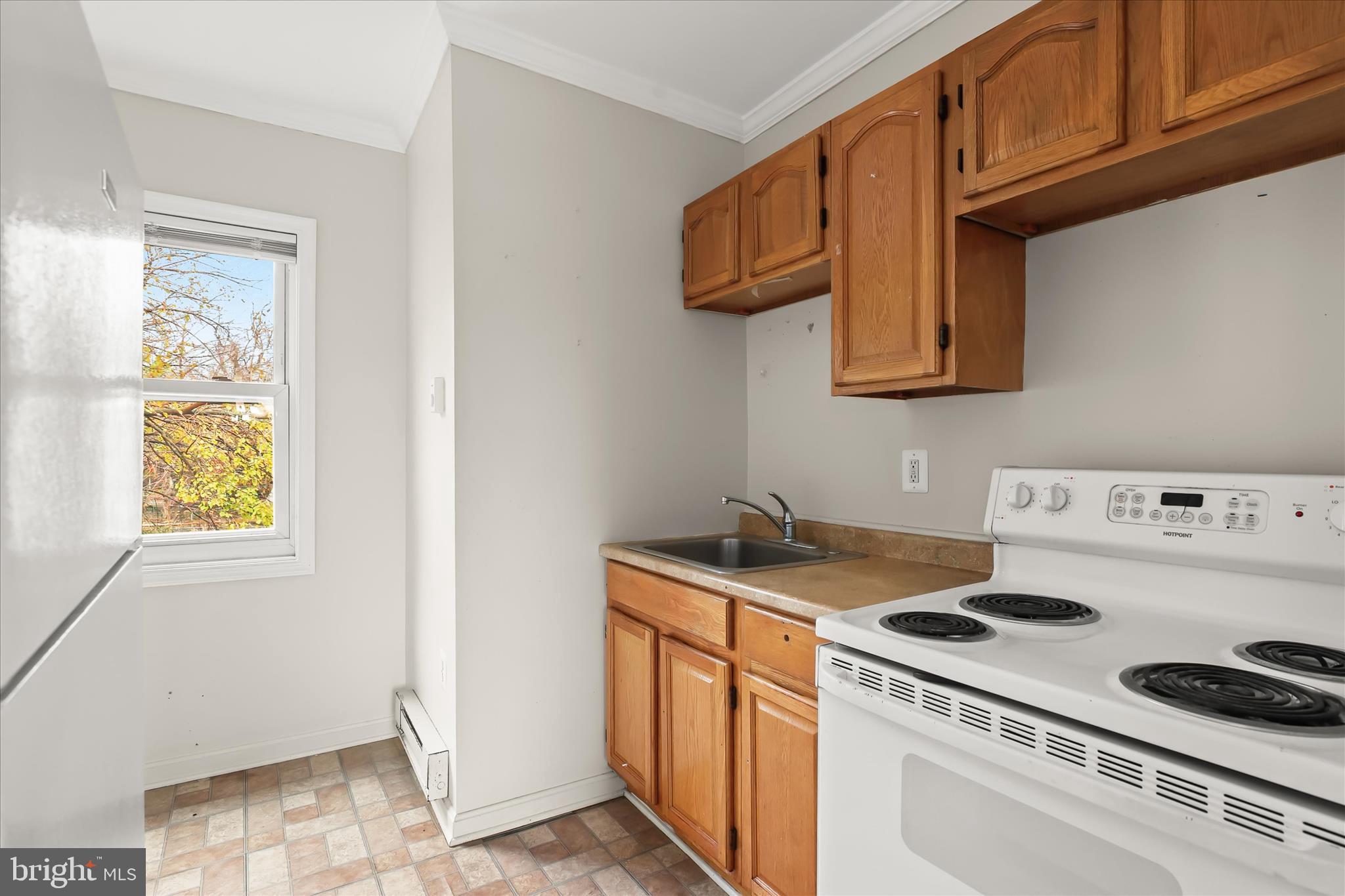 3511 6th Street Baltimore, MD 21225 - Photo 19 of 31 a kitchen with a stove and a microwave