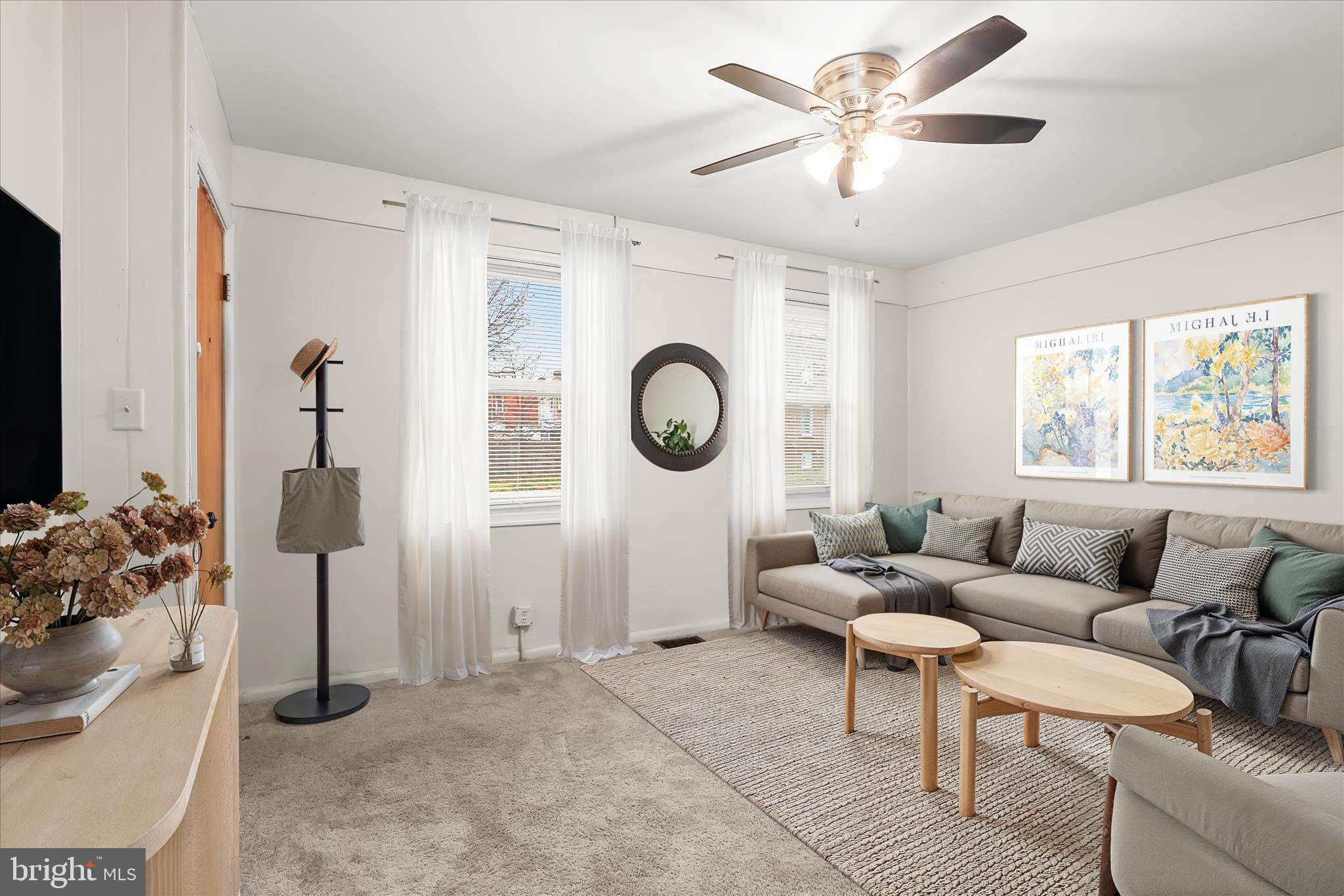 3511 6th Street Baltimore, MD 21225 - Photo 2 of 31 a living room with furniture a chandelier fan and a window