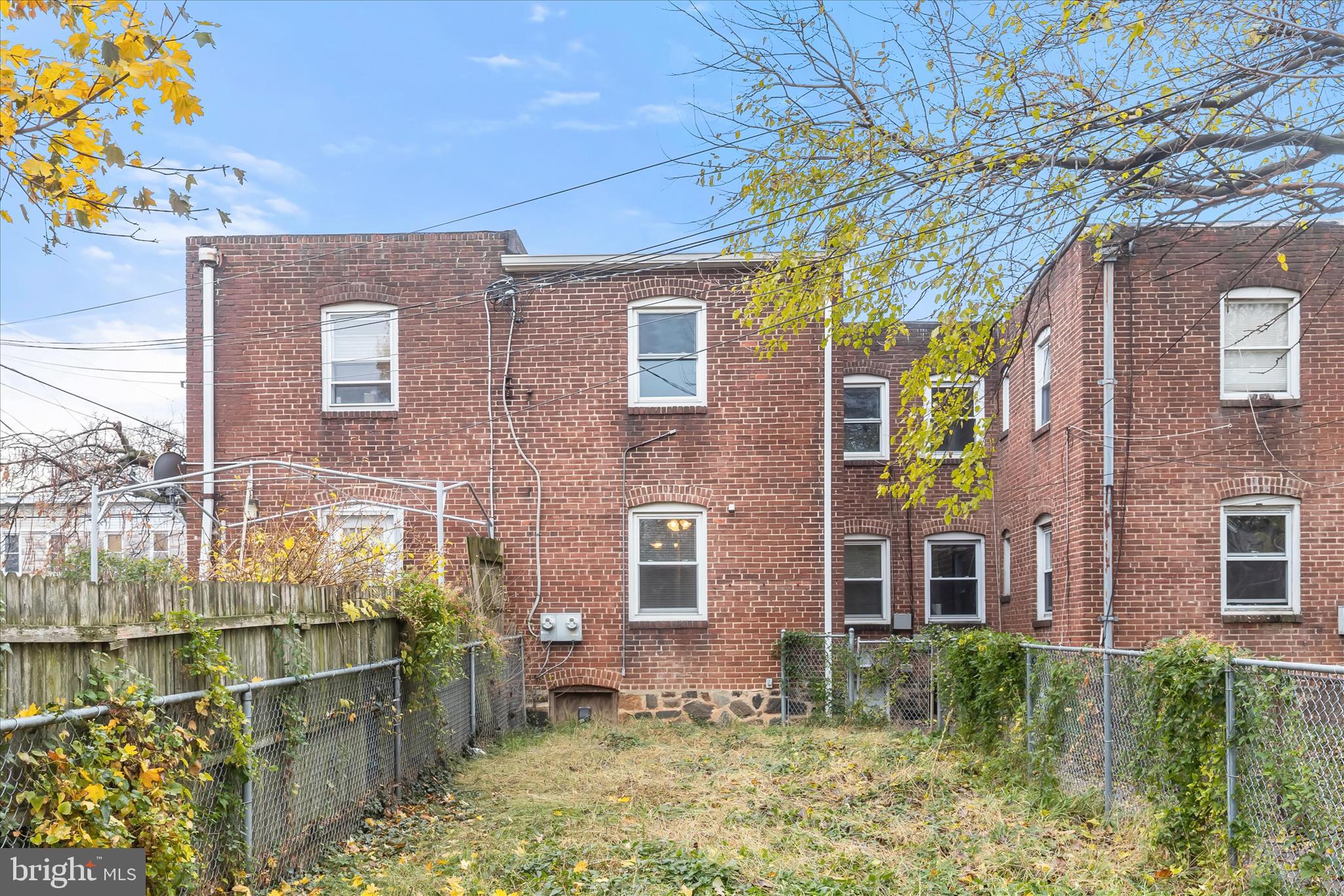 3511 6th Street Baltimore, MD 21225 - Photo 27 of 31 a view of a brick house with a large windows and plants