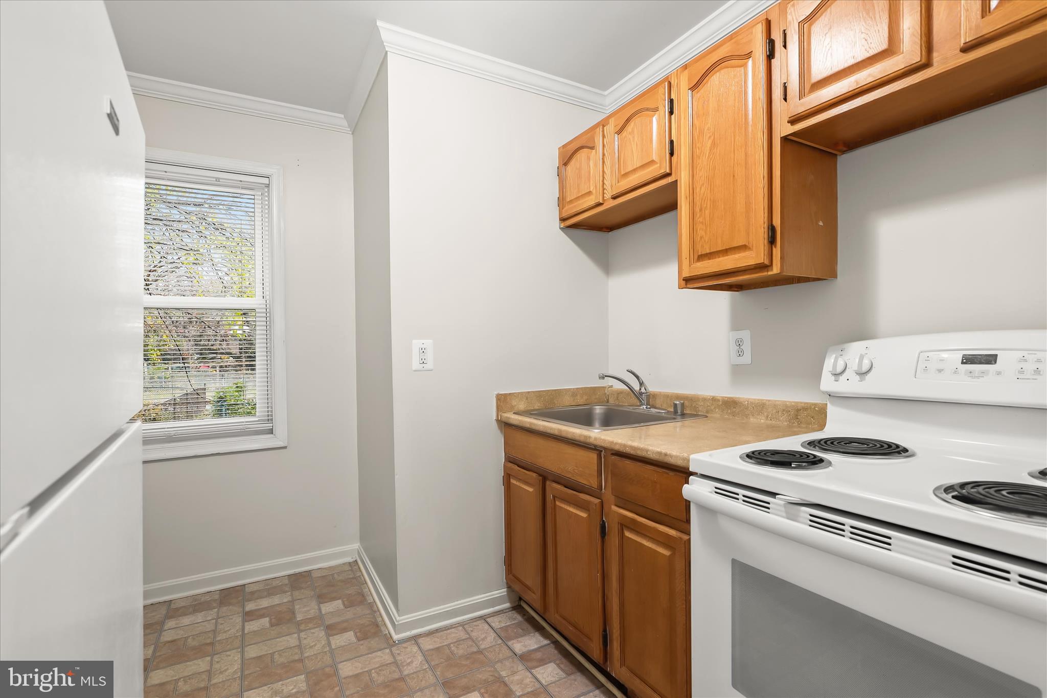 3511 6th Street Baltimore, MD 21225 - Photo 8 of 31 a kitchen with a stove and a microwave