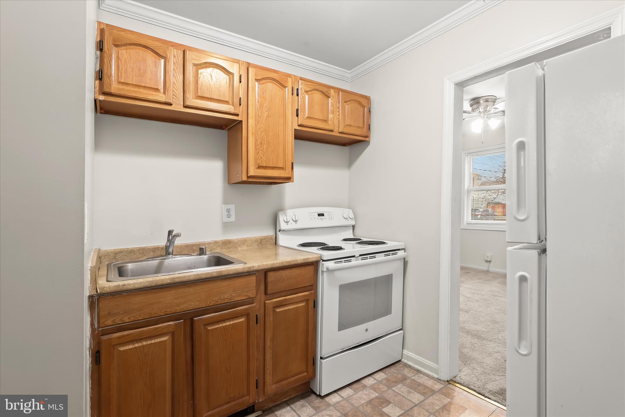 3511 6th Street Baltimore, MD 21225 - Photo 9 of 31 a kitchen with stainless steel appliances granite countertop a sink and cabinets with wooden floor