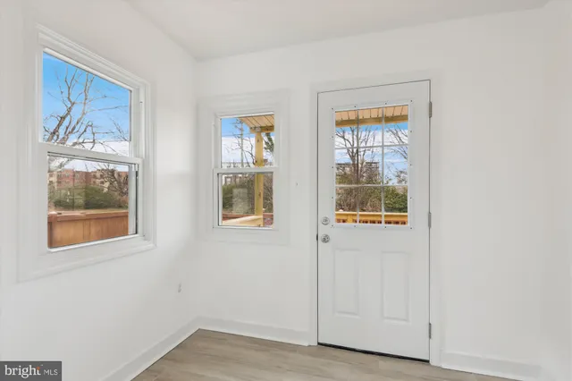a view of an entryway with wooden floor