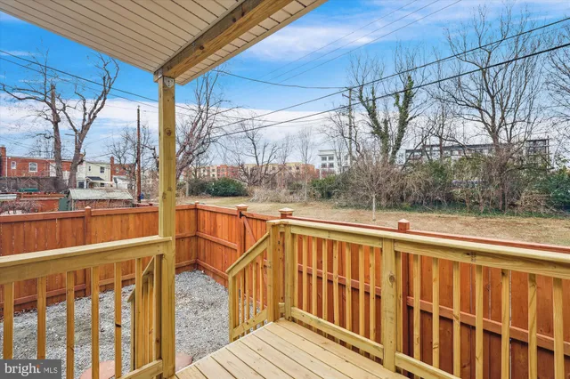 a view of a street with wooden fence
