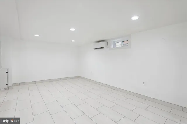 an empty room with white walls and tiles