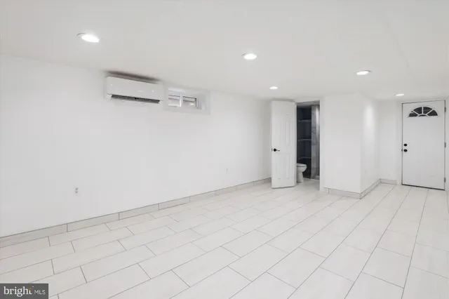an empty room with white walls and tiles