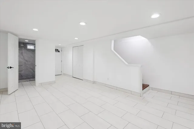 an empty room with white walls and tiles