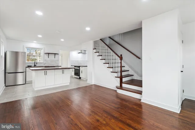 a view of kitchen with cabinets and wooden floor
