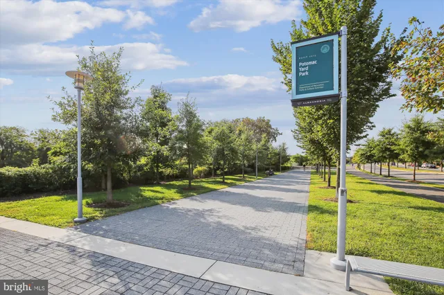 a front view of multi story residential apartment building with retail shops