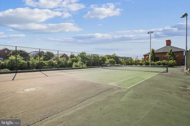 a view of a patio with chairs and table under an umbrella
