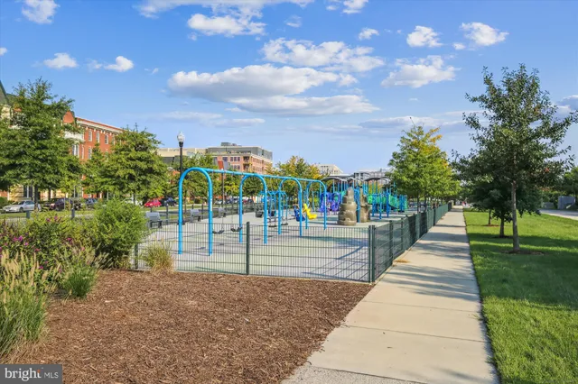a view of a cafe with a table and chairs under an umbrella