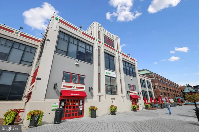 a view of a street sign under a large tree