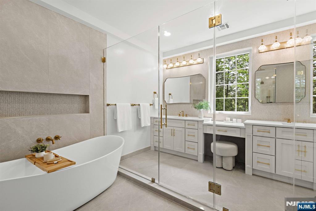14 Beechwood Road Ho-Ho-Kus, NJ 07423 - Photo 12 of 31 a bathroom with a tub sink and mirror