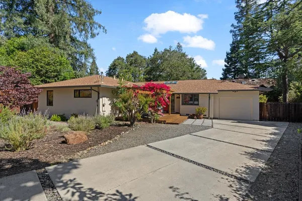 a front view of a house with garden