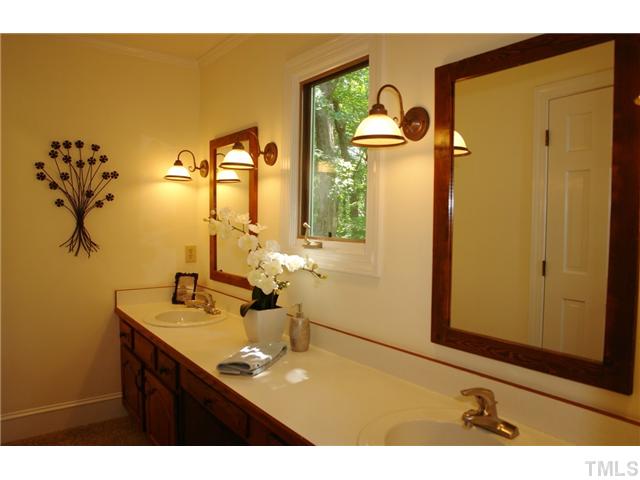 5001 Trail Ridge Drive Raleigh, NC 27613 - Photo 11 of 25 a bathroom with a sink vanity and a mirror