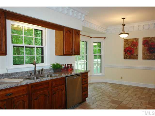 5001 Trail Ridge Drive Raleigh, NC 27613 - Photo 7 of 25 a kitchen with a sink window and cabinets