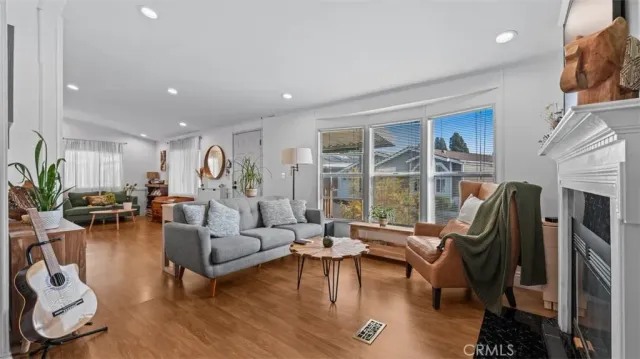 a living room with furniture floor to ceiling window and a flat screen tv