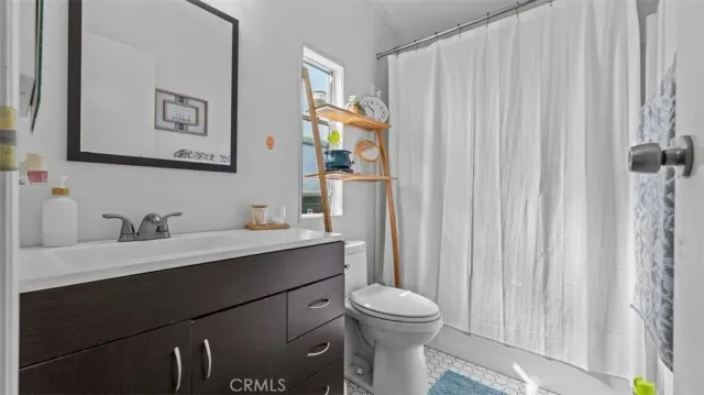 a bathroom with a toilet a sink and a mirror