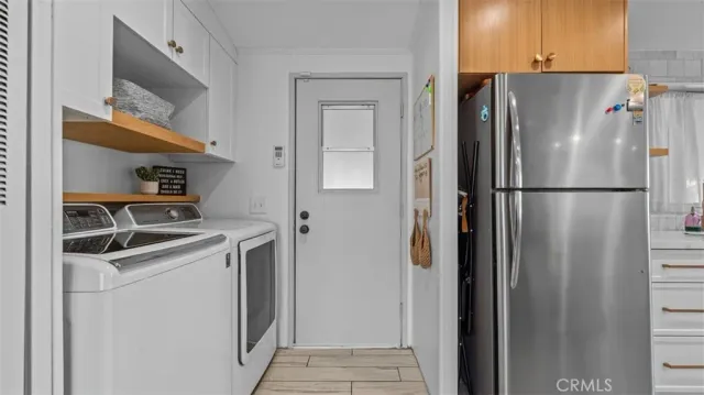 a white refrigerator freezer and a stove sitting inside of a kitchen