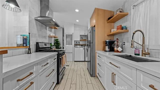a kitchen with kitchen island a sink appliances cabinets and a counter top space