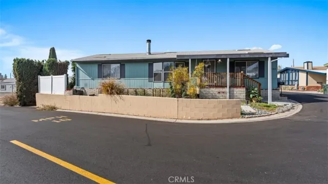 a view of a house with swimming pool and sitting area