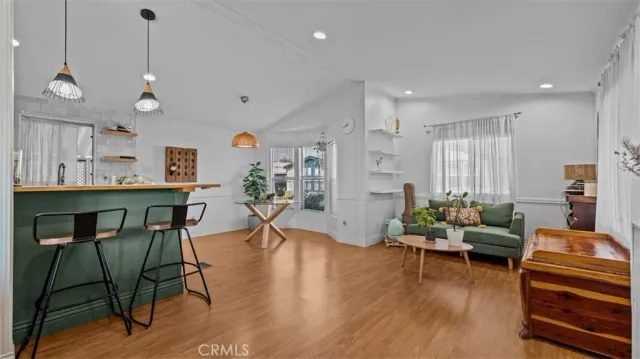 a living room with furniture a wooden floor and a chandelier