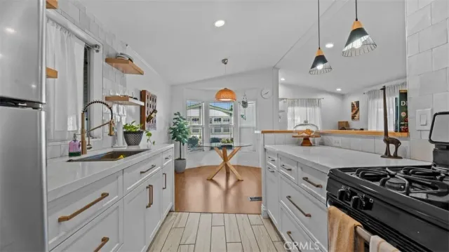 a kitchen with stainless steel appliances granite countertop a stove and cabinets