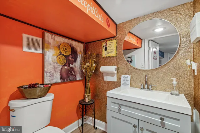 a bathroom with a toilet a sink and mirror