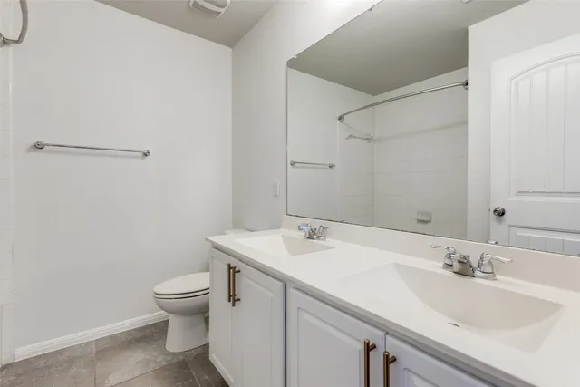 a bathroom with a sink mirror and toilet