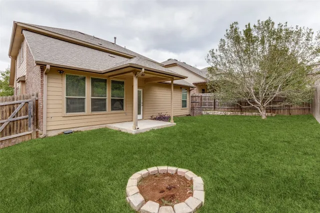 a view of a backyard with swimming pool