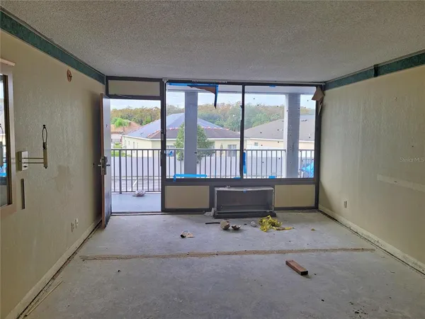 a living room with furniture and a floor to ceiling window